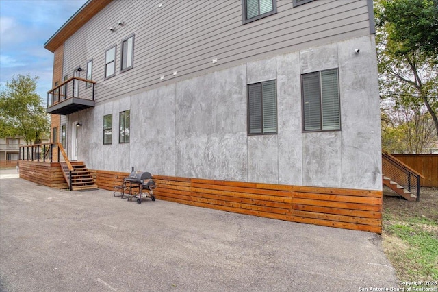 view of side of home featuring a balcony