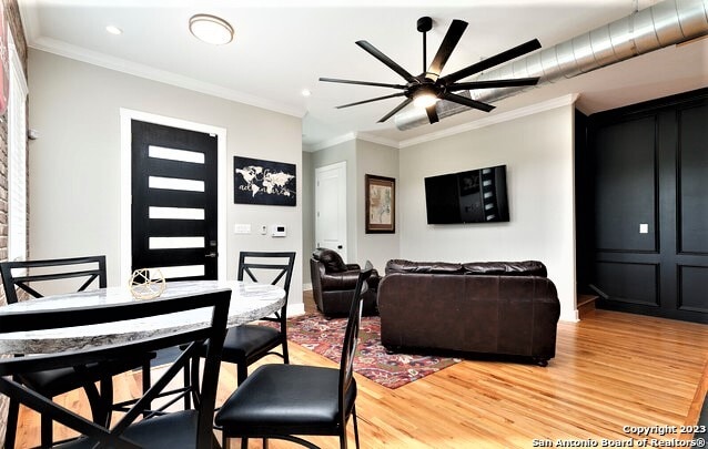 living room with ceiling fan, hardwood / wood-style floors, and ornamental molding