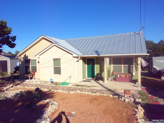 rear view of house featuring a porch