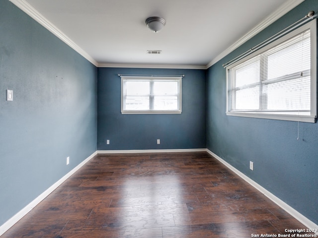 spare room featuring crown molding and dark hardwood / wood-style flooring