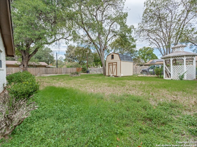 view of yard with a gazebo and a storage unit