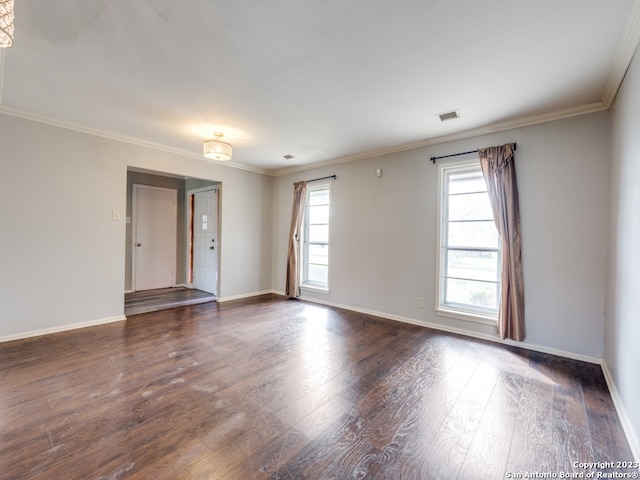 unfurnished room featuring dark hardwood / wood-style floors and ornamental molding