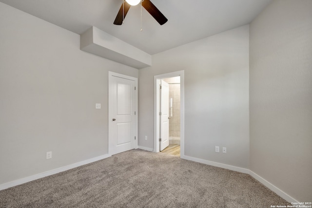 unfurnished bedroom with light carpet, ceiling fan, and ensuite bathroom