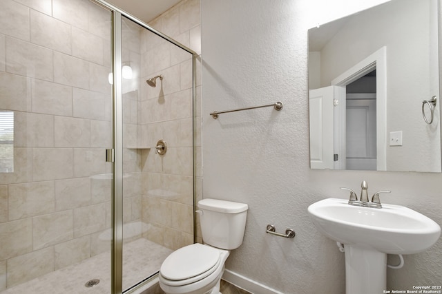 bathroom with toilet and an enclosed shower