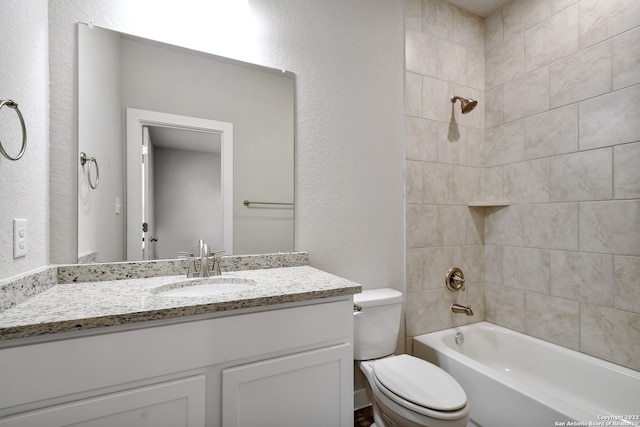 full bathroom with toilet, tiled shower / bath combo, and oversized vanity