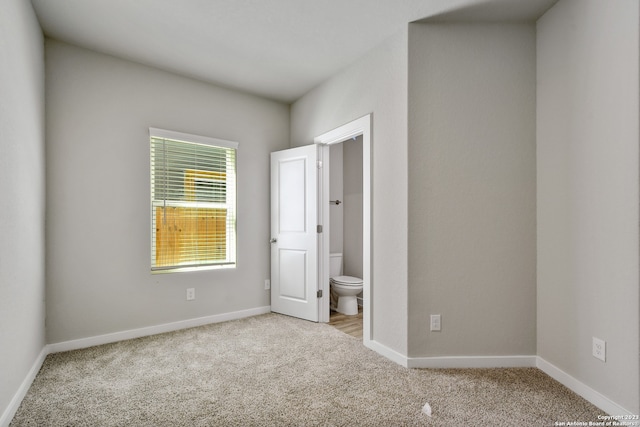 unfurnished room with light colored carpet