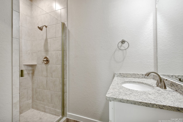 bathroom featuring vanity and a tile shower