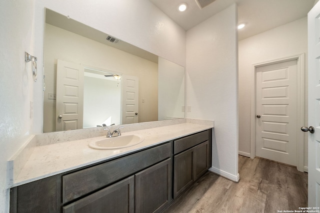 bathroom featuring ceiling fan, vanity, and wood-type flooring