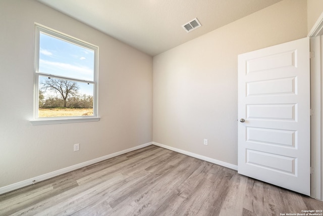 spare room with light hardwood / wood-style floors