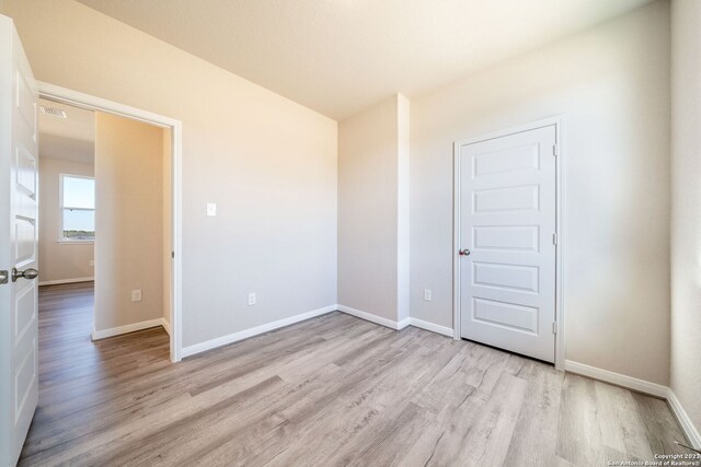 unfurnished room with light wood-type flooring