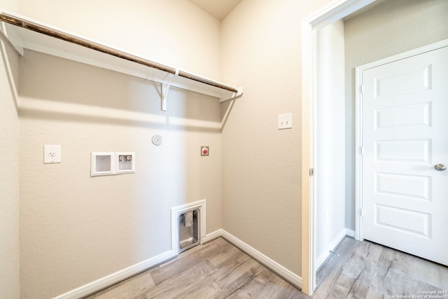 washroom featuring hookup for an electric dryer, light hardwood / wood-style floors, gas dryer hookup, and washer hookup