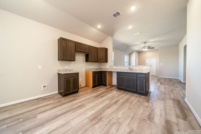 kitchen featuring lofted ceiling, sink, light hardwood / wood-style flooring, ceiling fan, and dark brown cabinetry