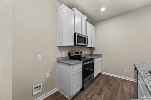 kitchen with stainless steel appliances, white cabinetry, light stone countertops, and dark hardwood / wood-style floors