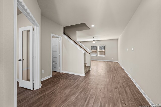 unfurnished living room featuring hardwood / wood-style flooring and ceiling fan