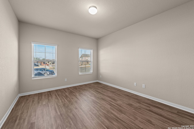 spare room featuring dark hardwood / wood-style flooring