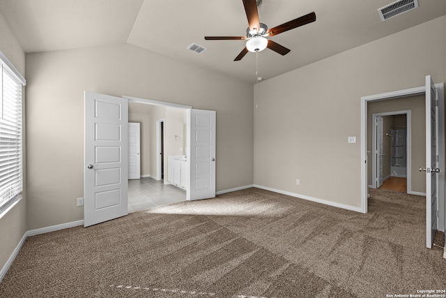 unfurnished bedroom with lofted ceiling, light colored carpet, and ceiling fan