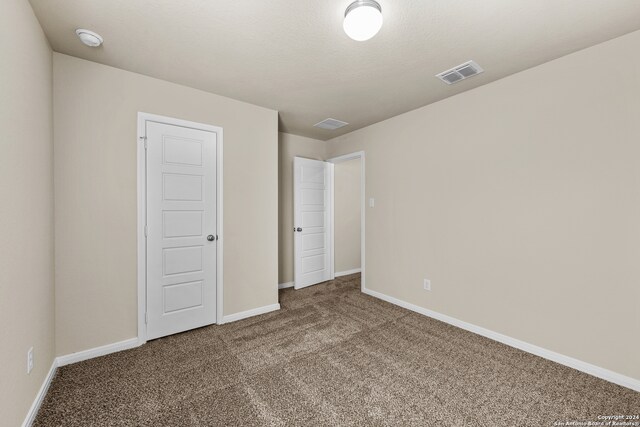 unfurnished bedroom with carpet