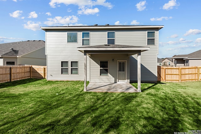 back of property with a patio and a lawn