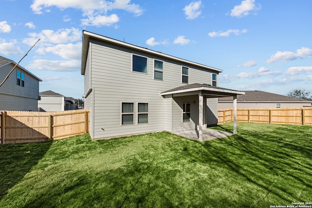 back of property featuring a patio area and a lawn