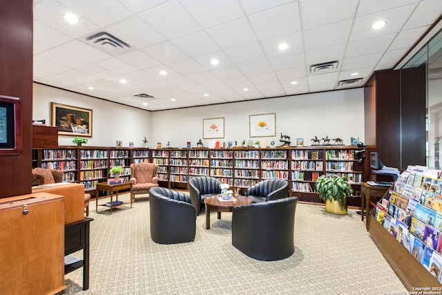 interior space featuring a drop ceiling and light colored carpet