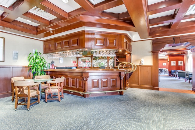 bar with beamed ceiling, carpet floors, coffered ceiling, and ornamental molding