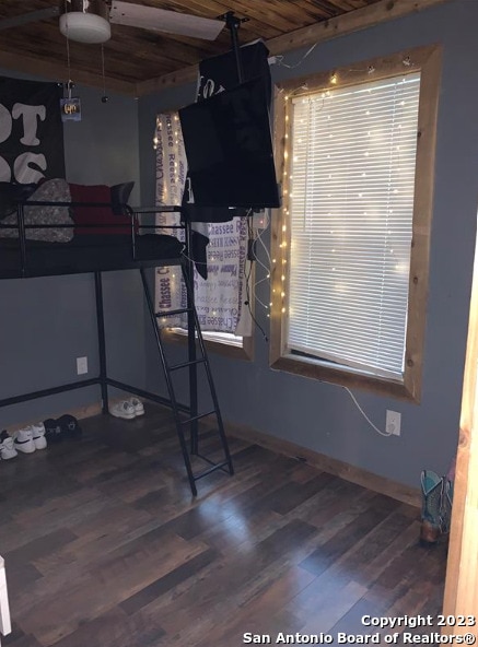 bedroom featuring wood-type flooring and wooden ceiling