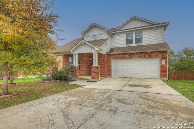 view of front of home with a front lawn and a garage