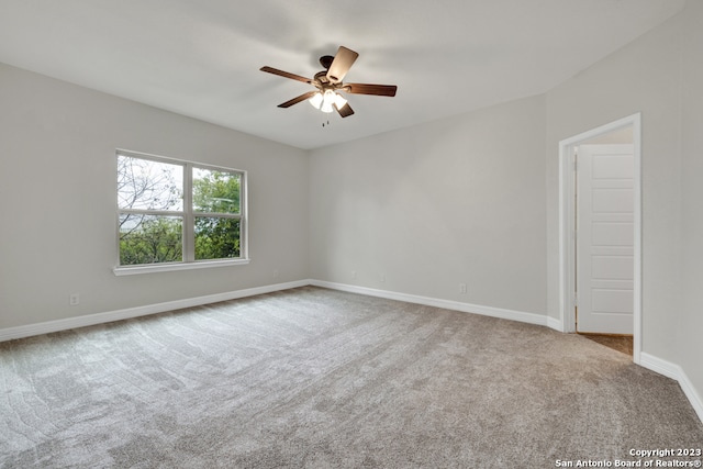 empty room with ceiling fan and light colored carpet