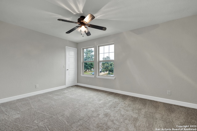 carpeted empty room with ceiling fan