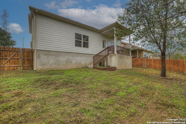 rear view of house featuring a yard