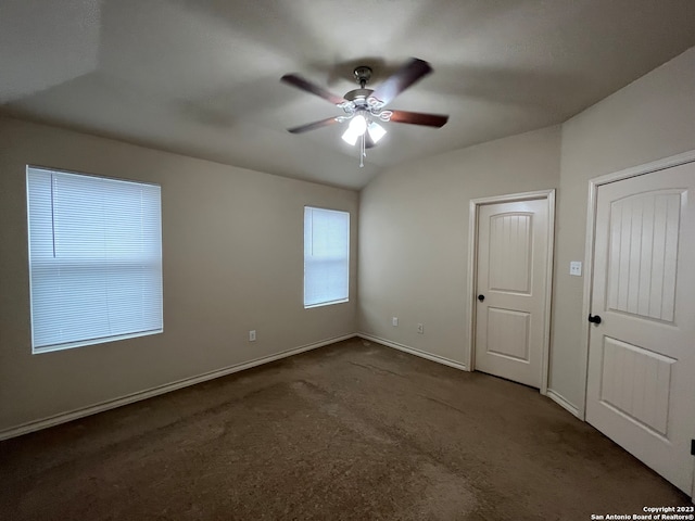 unfurnished bedroom featuring ceiling fan and dark carpet