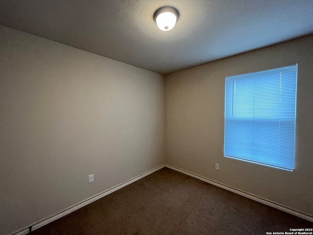 empty room with dark carpet