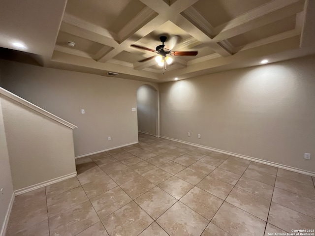 spare room with coffered ceiling, ceiling fan, beamed ceiling, and light tile floors