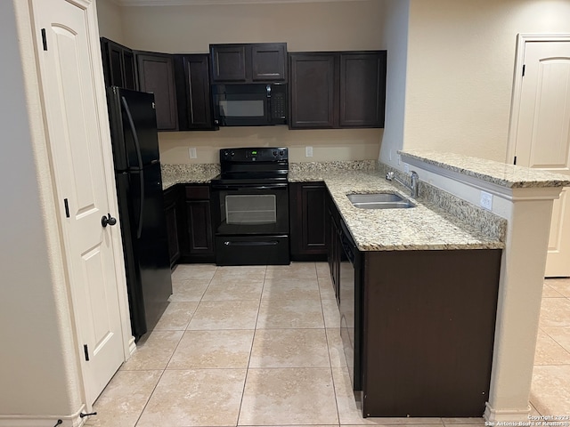 kitchen with light tile flooring, sink, light stone counters, and black appliances