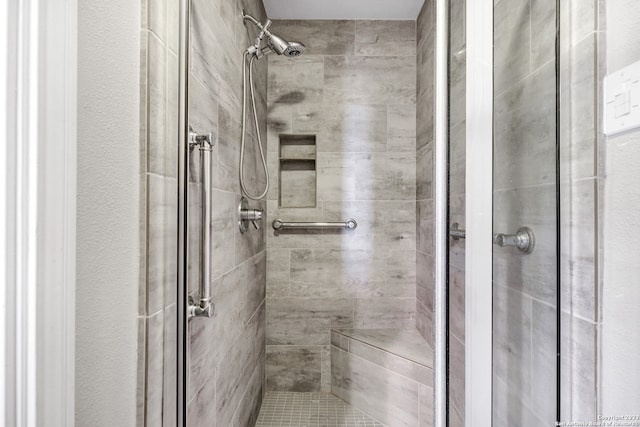 bathroom with tiled shower