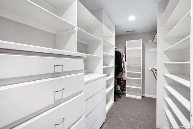 spacious closet featuring dark carpet