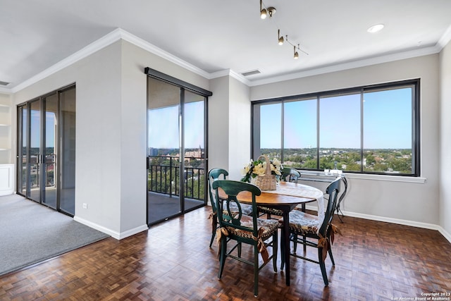 dining space featuring ornamental molding and dark parquet floors