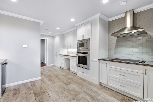 kitchen featuring backsplash, white cabinetry, appliances with stainless steel finishes, and wall chimney exhaust hood