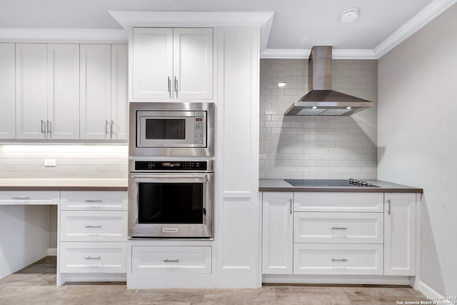 kitchen featuring crown molding, appliances with stainless steel finishes, backsplash, wall chimney exhaust hood, and white cabinetry