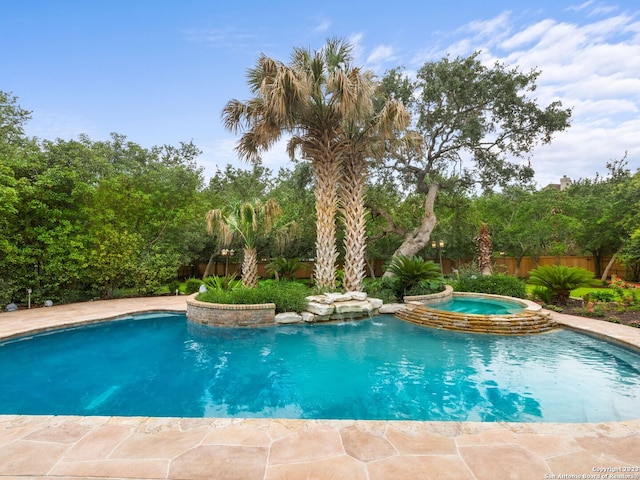 view of pool with an in ground hot tub