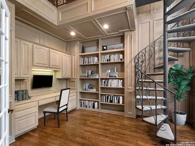 office area with coffered ceiling, dark hardwood / wood-style flooring, built in desk, built in shelves, and ornamental molding