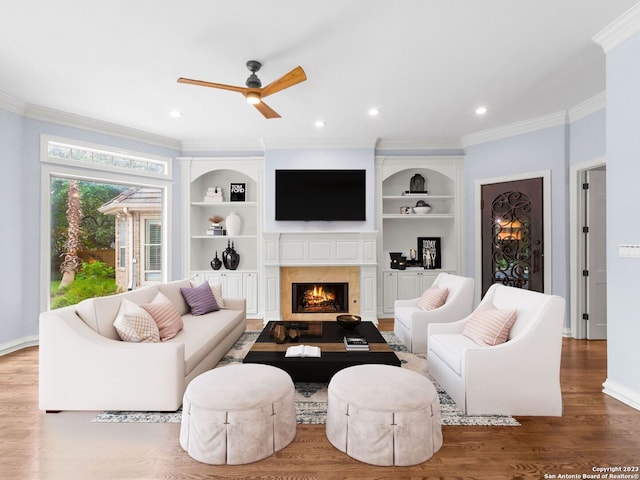 living room with ceiling fan, crown molding, and hardwood / wood-style floors