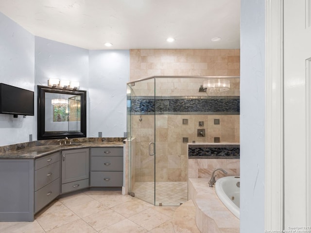 bathroom with tile flooring, shower with separate bathtub, and vanity