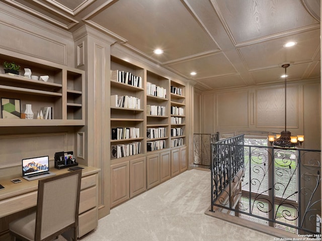 interior space featuring built in features, coffered ceiling, a chandelier, and light colored carpet