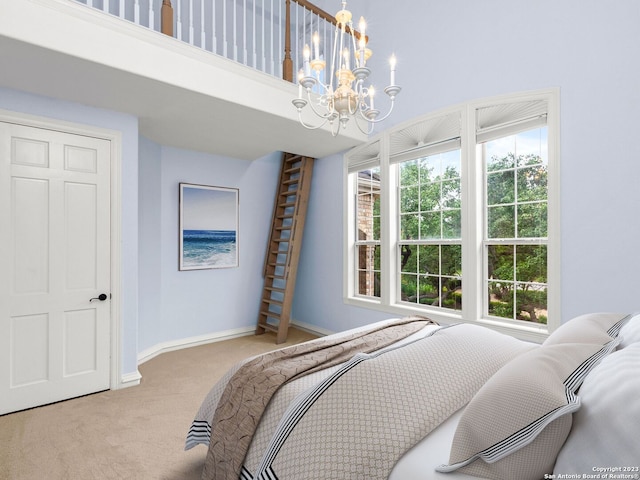 bedroom featuring a chandelier and light colored carpet