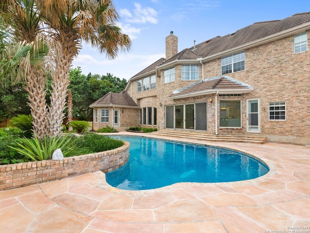 view of swimming pool with a patio