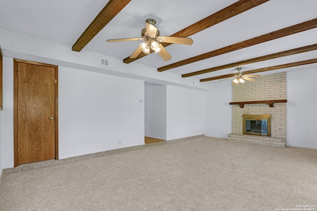 unfurnished living room with carpet, beam ceiling, and a brick fireplace