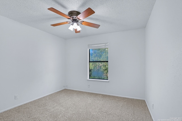 empty room featuring a textured ceiling, carpet flooring, and ceiling fan