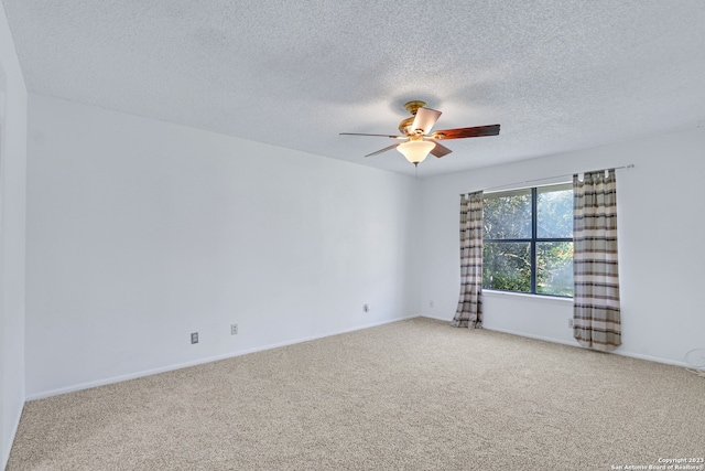 unfurnished room featuring carpet flooring, ceiling fan, and a textured ceiling