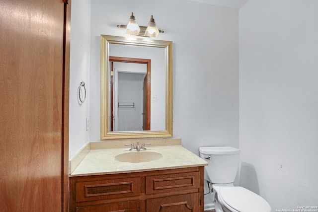 bathroom with toilet and vanity